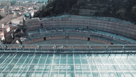 Aerial-fly-over-symmetry-of-Orange's-Roman-Theatre-in-Vaucluse,-France