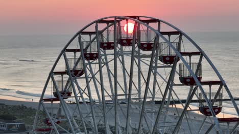 Gorgeous-sunrise-in-Ocean-City,-NJ-rising-over-the-ferris-wheel-at-Wonderland-Pier