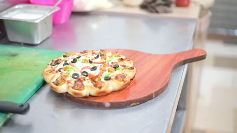 Pizza-chef-serving-freshly-baked-pizza