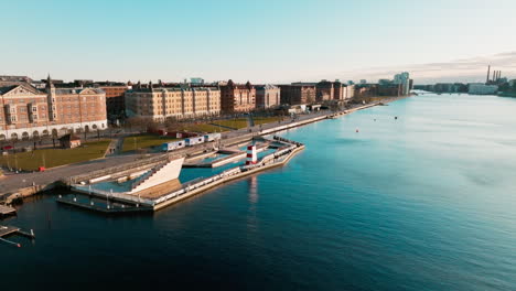 panorama-moving-drone-shot-of-the-downtown-skyline-of-copenhagen-in-Denmark-of-the-river-Tryggevælde-by-sunset