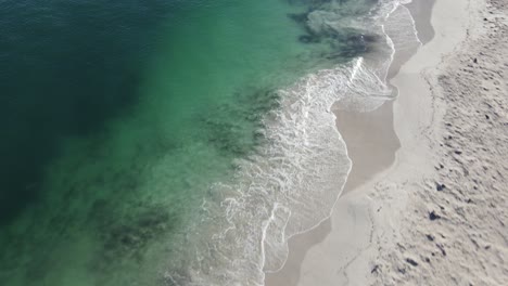 Drone-aerial-close-to-pristine-coastline-with-black-smudges-in-water