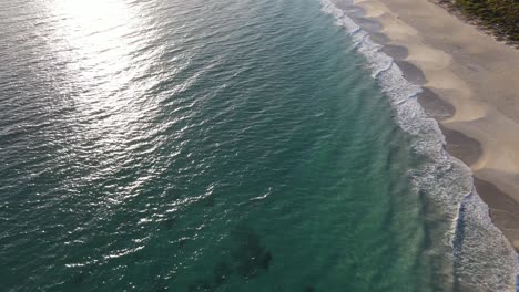 Drone-aerial-panning-down-over-a-beautiful-blue-beach-with-white-sand-in-Western-Australia