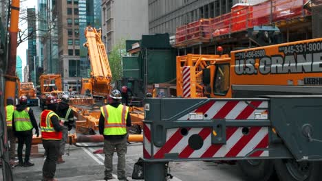 A-stationary-shot-of-men-on-the-street-at-a-construction-site-in-New-York-City-on-a-cloudy-day