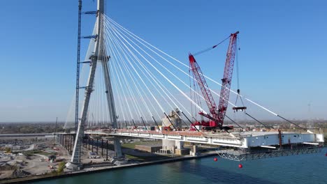 Gordie-Howe-International-Bridge-being-built-with-massive-cranes,-aerial-view