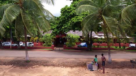 Drone-flyover-sand-beach-toward-Omaldi-Resort-entrance-in-São-Tomé-e-Principe-Island