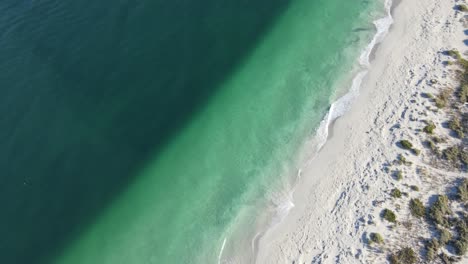 Drohnenaufnahme-Eines-Unberührten-Strandes-Mit-Einer-Klaren-Linie-Im-Wasser