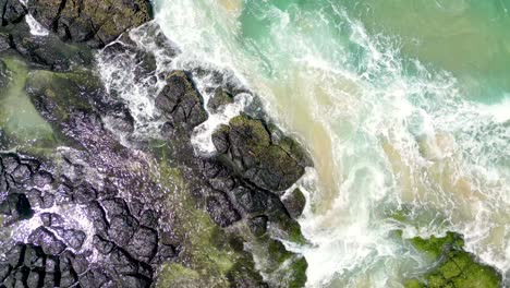 Looking-down-at-rocks-next-to-Cudgen-Creek-at-Kingscliff-in-New-South-Wales-in-Australia