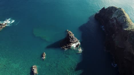 Drone-Footage-of-Ocean-Rocks-and-Calm-Water-on-Sunny-Day