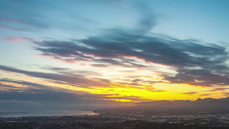 Timelapse-shot-from-evening-to-night-over-city-of-Malaga,-Spain-during-evening-time