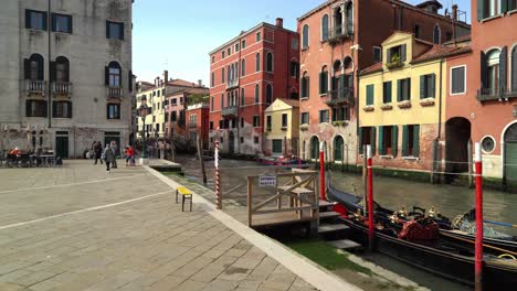 Gondolas-bear-the-Water-Canal-in-Venice-on-a-Lovely-Spring-Day