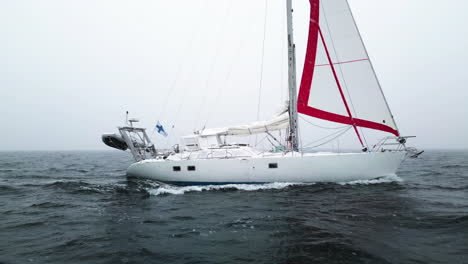 AERIAL:-Finnish-sailboat-sailing-in-a-dangerous-snowstorm-with-low-visibility