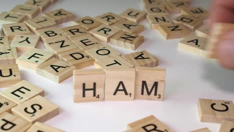 Close-up-on-white-table:-Word-HAMAS-formed-with-Scrabble-letter-tiles