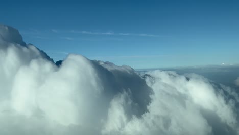 POV-immersive-pilot-perspective-flying-over-and-through-a-stormy-cloud-over-the-Sea-in-a-slpendid-and-bright-sunny-day
