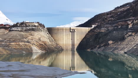 Aerial-View-Dam-Empty-Chevril-Lake-Tignes-Savoie-France-Reflection-Geometric-Lines-Blue-Sky-Winter-Mountains