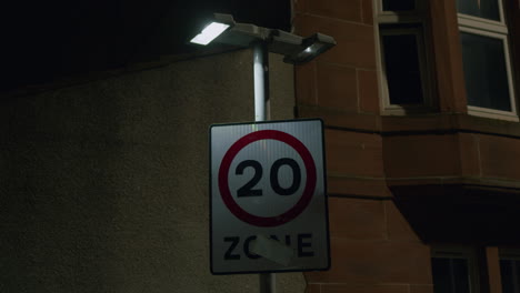 Flashing-street-light-witj-20-Zone-road-sign---twenty-mph-UK-speed-limit,-late-night-shot