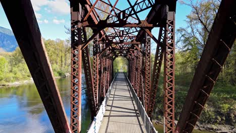 Slow-relaxing-shot-of-bridge-crossing-Snoqualmie-Middle-Fork-River-in-North-Bend,-Washington-State