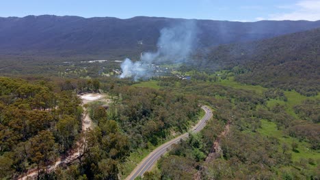 Panning-aerial-view-of-smoke-spreading-over-Crackenback-area-in-NSW,-Australia