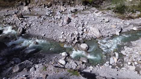 Drone-Slowly-following-Mountain-River-with-Crystal-Clear-Water-in-Austria,-Europe