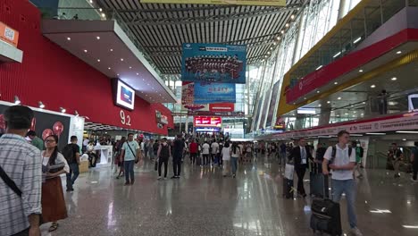 Walking-through-the-hall-of-Canton-Fair-Complex-with-numerous-foreign-buyers-attending-the-trade-exhibition