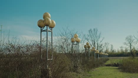 Row-of-spherical-street-lamps-in-an-abandoned-area-overgrown-with-vegetation,-Zagreb-Croatia