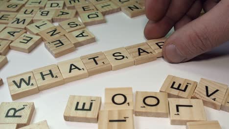 Male-hand-forms-social-media-word-WHATSAPP-from-Scrabble-tile-letters