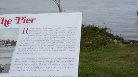 Rocky-Point-Park-info-plaque-showing-old-pier,-pans-to-modern-day-destroyed-dock