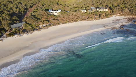 Drone-aerial-panning-up-over-a-pretty-beach-with-white-sand-in-Western-Australia