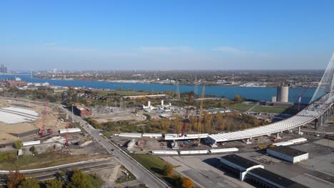 Gordie-Howe-International-Bridge-and-commercial-building-construction-site,-aerial-drone-view