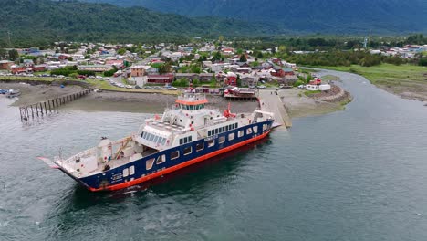 Aerial-View-Of-Ferry-Boat-Docking-At-Ramp-In-Hornopiren-Town-Located-In-Commune-Of-Hualaihué-in-Palena-Province,-Southern-Chile