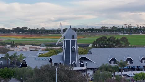 Carlsbad-Windmill-Partial-Far-Away-Circular-Drone-Flight-With-Parallax-Effect-Flower-Fields-In-The-Background