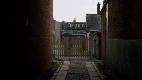 Gloomy-view-on-a-typical-back-alley-view-between-houses-in-United-Kingdom