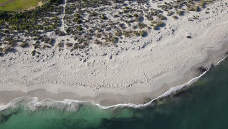 Drone-aerial-panning-up-from-the-beach-to-the-coastal-town-of-Jurien-Bay-in-Australia