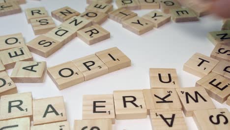 Closeup-Scrabble-tile-letters-form-drug-word-OPIOIDS-on-table-top