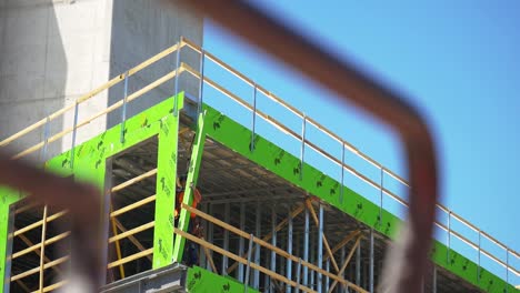 laborer-on-the-top-floor-of-jobsite-frames-the-walls