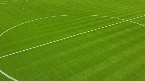 Close-up,-low-angle-aerial-view-of-a-portion-of-a-lush-green-soccer-field