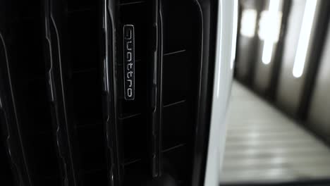 Vertical-Shot-Of-Audi-Quattro-Emblem-On-Radiator-Grille