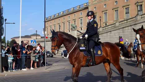 Royal-Guards-and-Police-on-horses-on-Sweden's-National-Day-in-Stockholm,-slo-mo