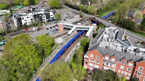Drone,aerial-tracking-colourful-train-at-Virginia-Water-station-Surrey-UK