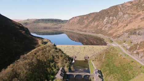 An-aerial-view-of-Caban-Coch-dam-and-reservoir-on-a-sunny-spring-day-in-the-Elan-valley,-Powys,-Wales