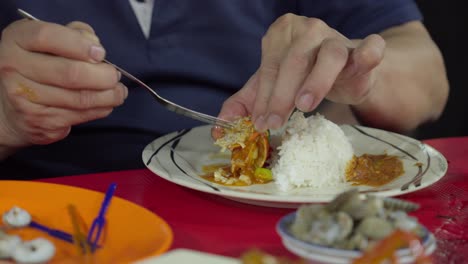 Asian-old-elder-person-eat-Cooked-Crab-in-traditional-restaurant-Indonesian-food