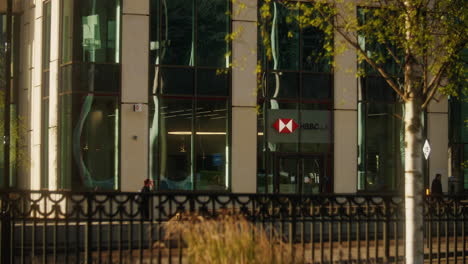 A-static-shot-of-commuters-and-employees-walking-past-HSBC’s-Birmingham-HQ-on-a-sunny-morning