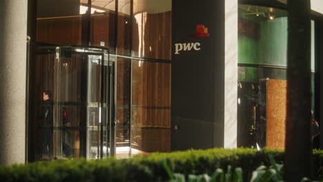 Moving-past-PWC-as-employees-walk-in-to-their-Birmingham-Offices