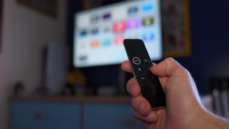 A-Hand-Operating-the-Apple-TV-Remote-Control---Close-Up