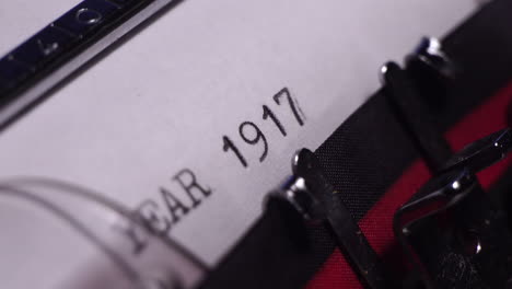 Year-1917,-Typing-on-White-Paper-in-Vintage-Typewriter,-Macro-Close-Up