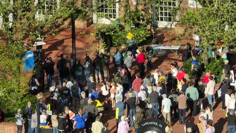 Lancaster-Clock-in-front-of-Protester-Group-at-sunny-day