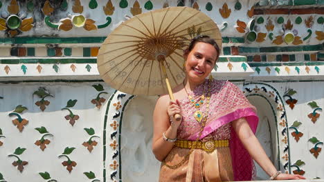 Cheerful-blonde-woman-with-Thai-costume-smiling-at-camera