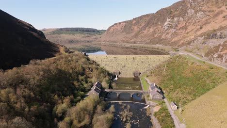 An-aerial-view-of-Caban-Coch-dam-and-reservoir-on-a-sunny-spring-day-in-the-Elan-valley,-Powys,-Wales