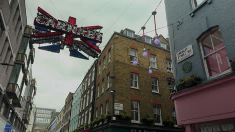 Carnaby-sign-hanging-in-the-air---Union-Jack,-Carnaby-Street,-London,-Day,-low-angle-with-buildings