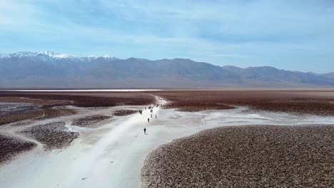 Tourists-Walking-On-Badwater-Basin-In-Death-Valley-National-Park,-Inyo-County,-California