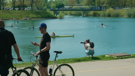 Outdoor-leisure-at-Jarun-Lake,-Zagreb-with-rowers,-bikers,-and-photographer